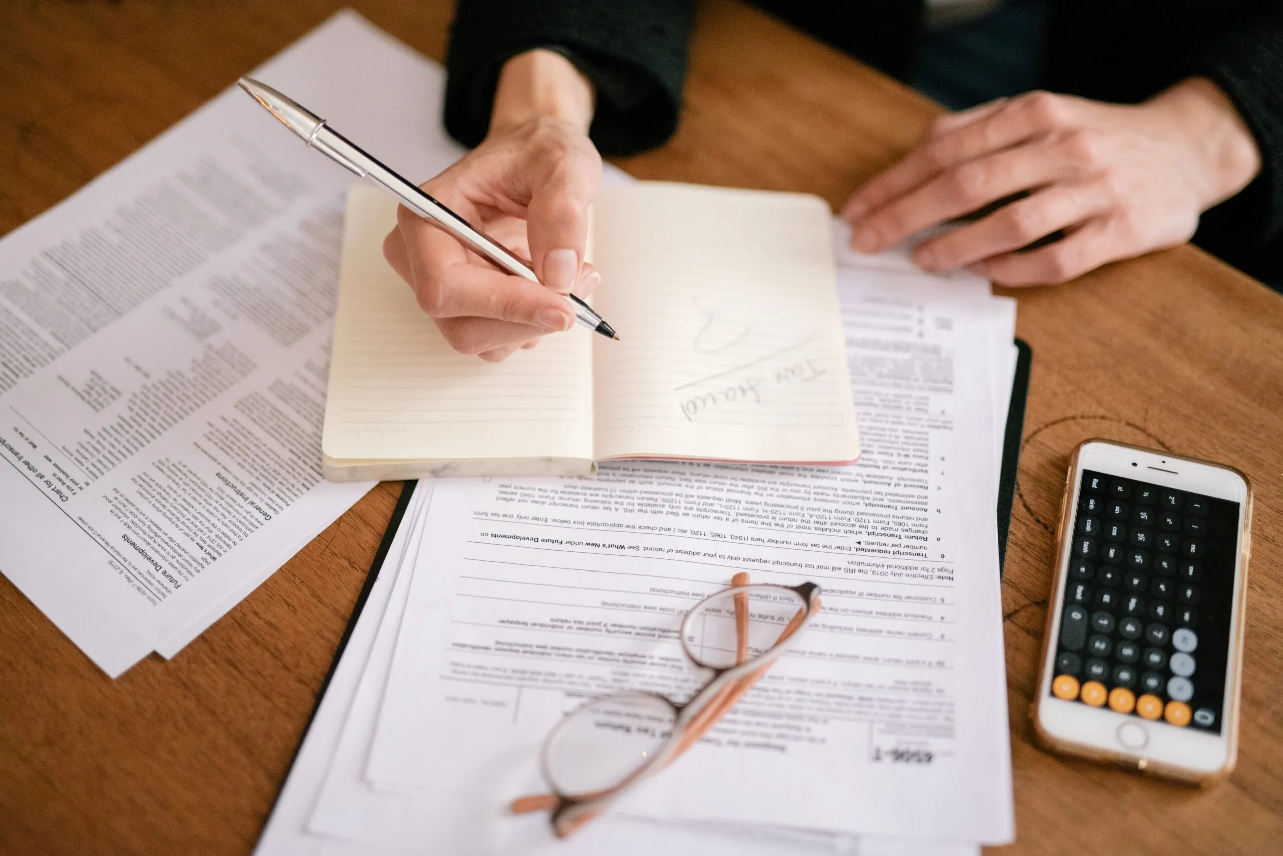 Table with paper and calculator, tax forms